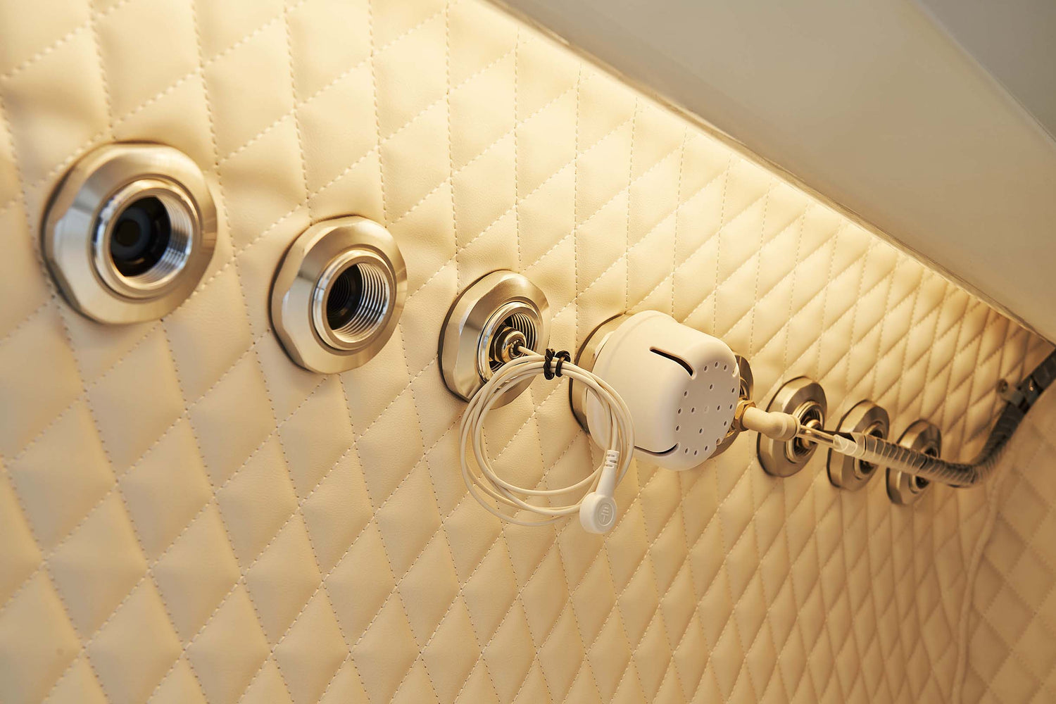 Back view of a hyperbaric oxygen chamber with connections and control panel displayed.