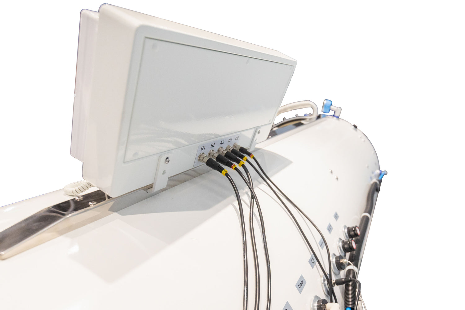 Back view of a hyperbaric oxygen chamber with connections and control panel displayed.