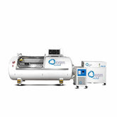 Back view of a hyperbaric oxygen chamber with connections and control panel displayed.