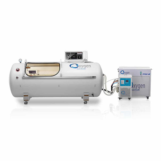 Back view of a hyperbaric oxygen chamber with connections and control panel displayed.