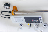 Back view of a hyperbaric oxygen chamber with connections and control panel displayed.